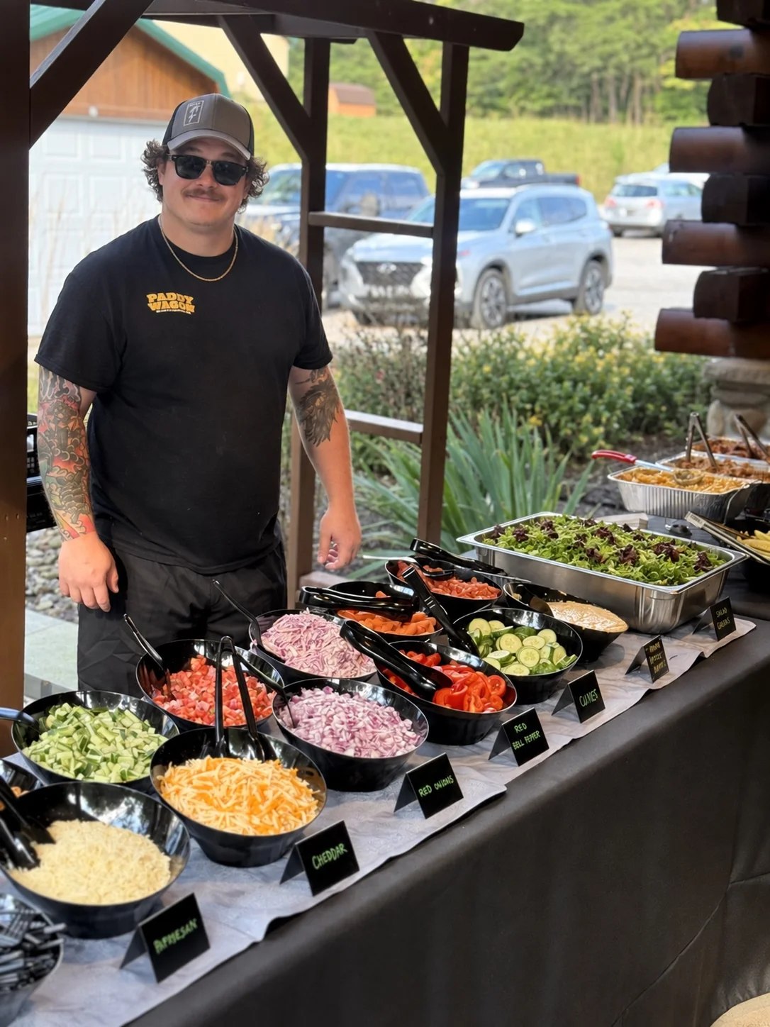 A Paddy Wagon crew member beside a prepared catering buffet